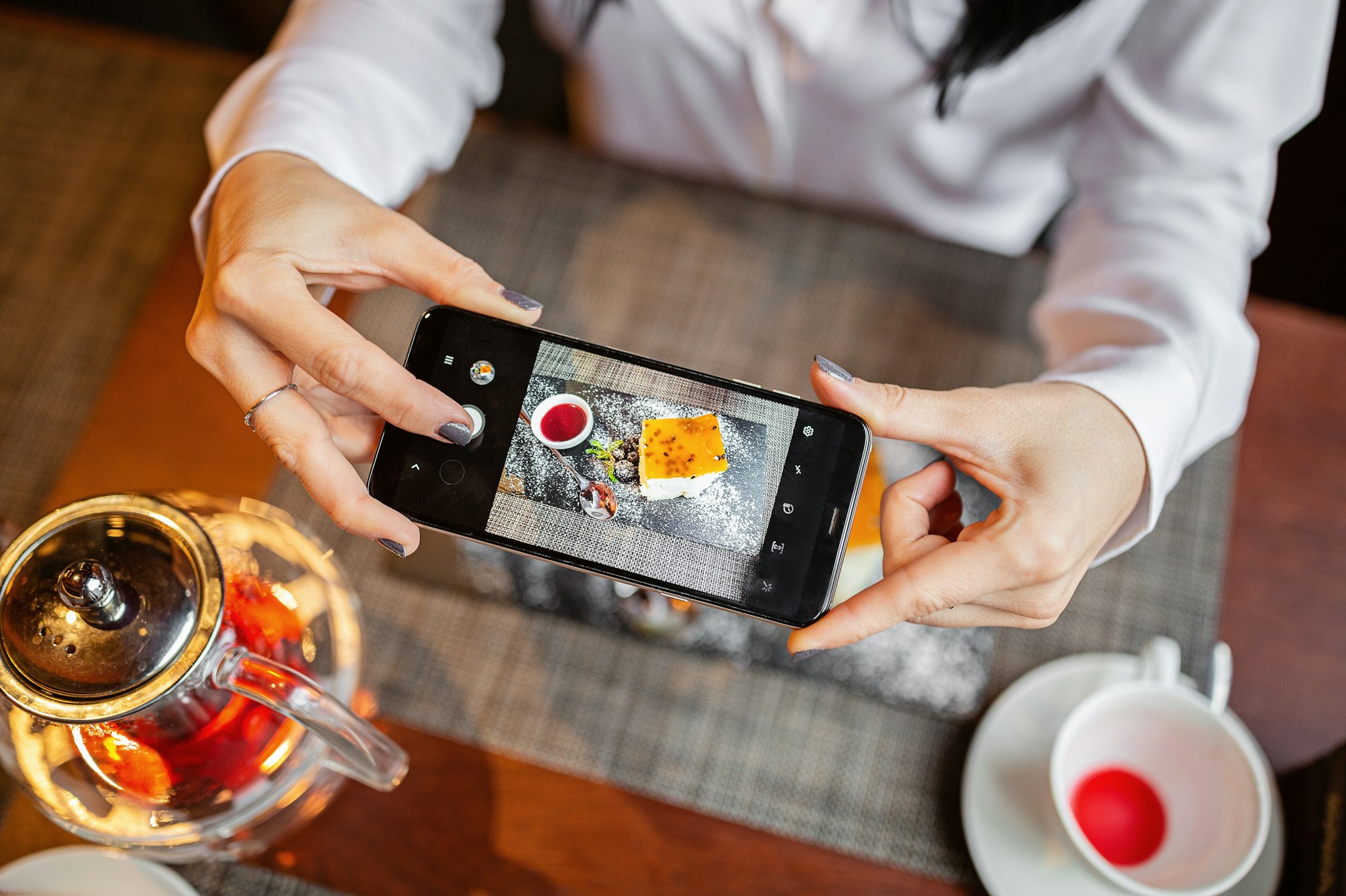 Blogger taking food photos in restaurant